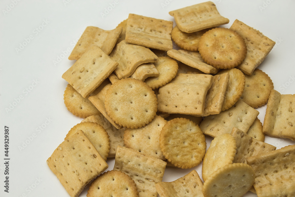 top view of salty square and round shaped cookies on white background top view of salty square and round shaped cookies on white background