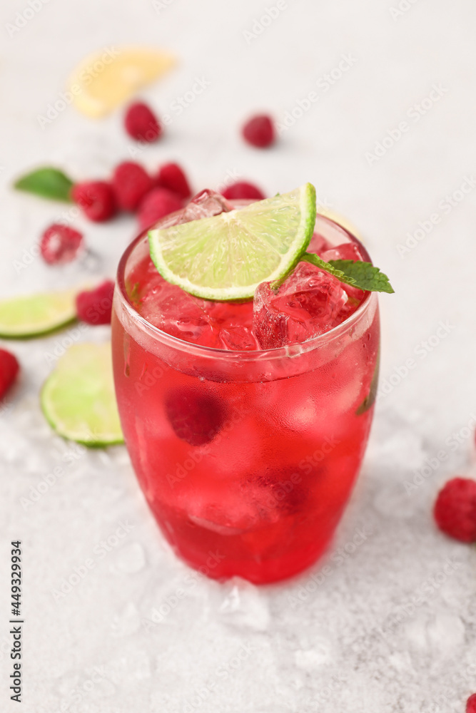 Glass of cold raspberry lemonade on light background Glass of cold raspberry lemonade on light background