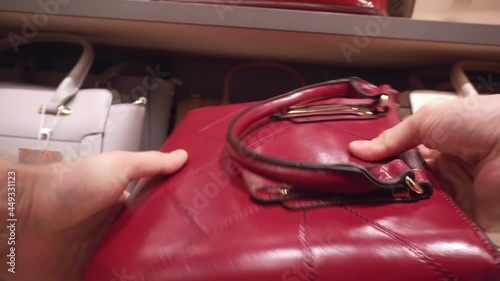 Choosing a handbag for a gift in the store. Shopping for fashionable and quality items, close-up, purchase
