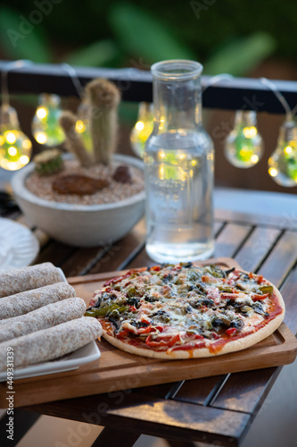 Delicious pizza on a wood table with fajitas
