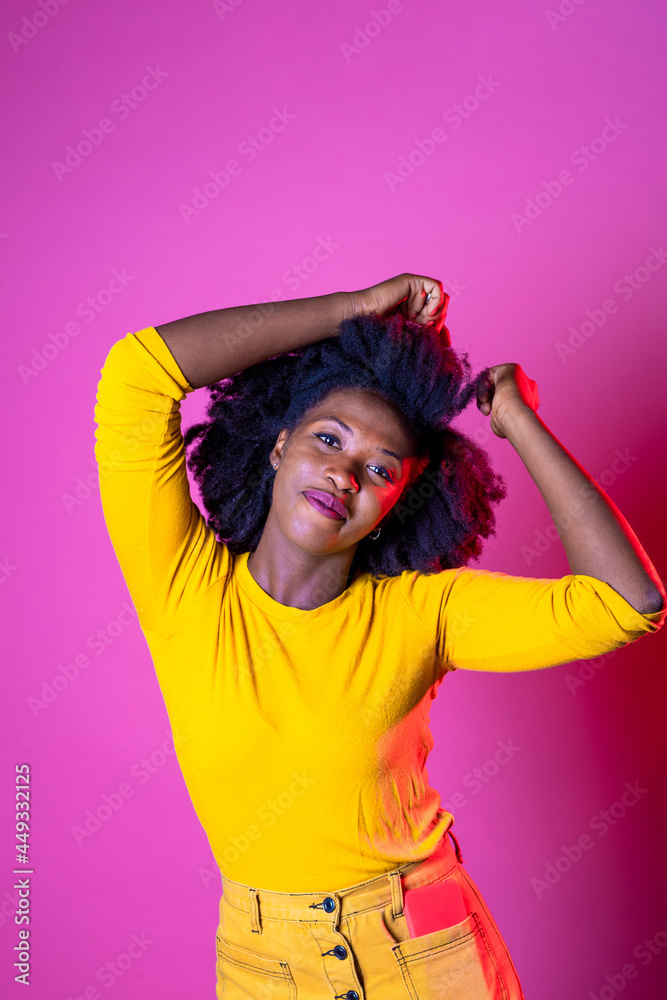 Young black woman isolated background enjoying music dancing smiling positive and friendly Young black woman isolated background enjoying music dancing smiling positive and friendly