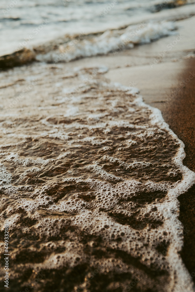 Beautiful scenery of the beach with splashing sea waves..
