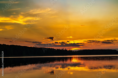 a beautiful landscape with a golden sunset over the water