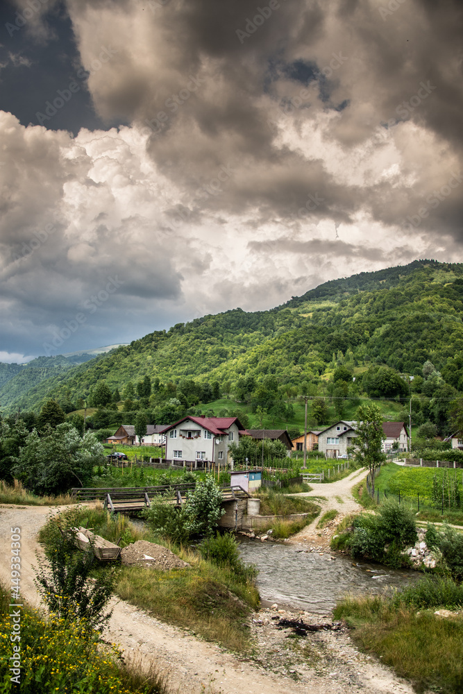 Mountain landscape with a river and clouds in the Anies area, Bistrita, 2021