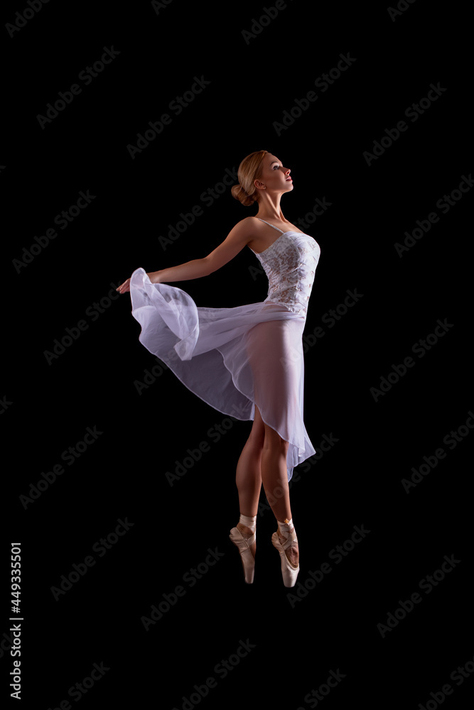 beautiful Ballerina dancer in studio on a dark background