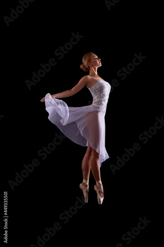 beautiful Ballerina dancer in studio on a dark background