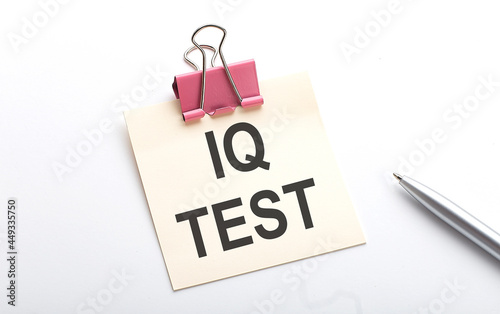 IQ TEST text on sticker with pen on the white background
