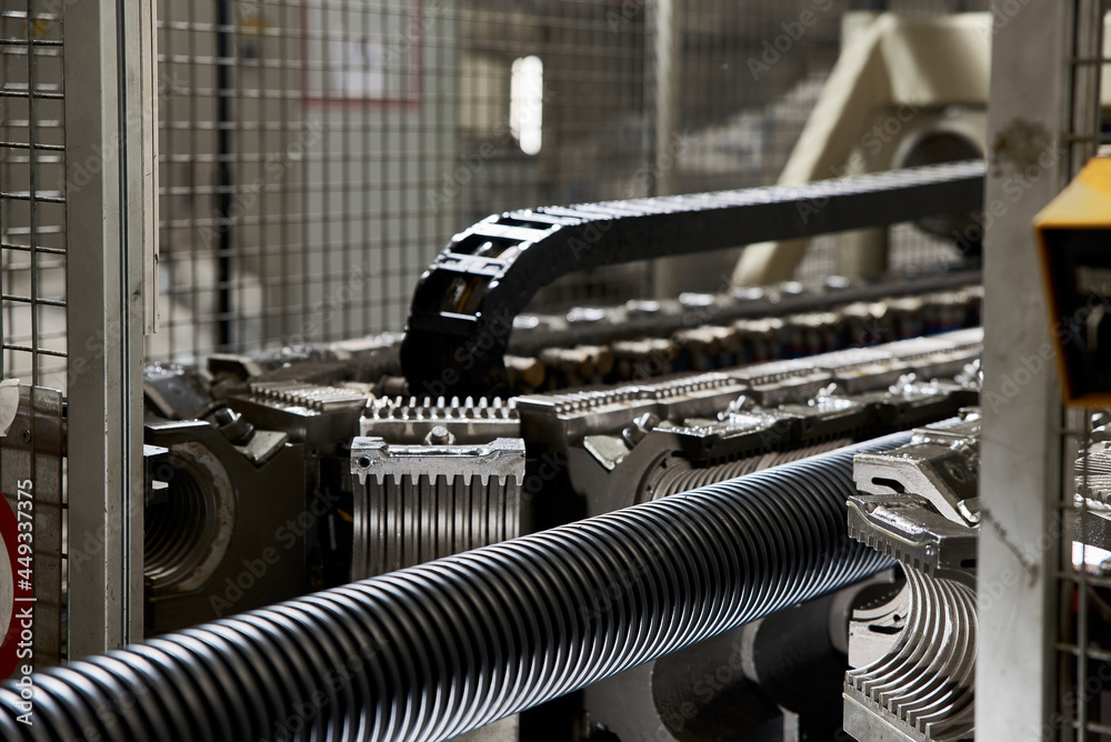 Production of a plastic pipe at a factory. Stock Photo Adobe Stock
