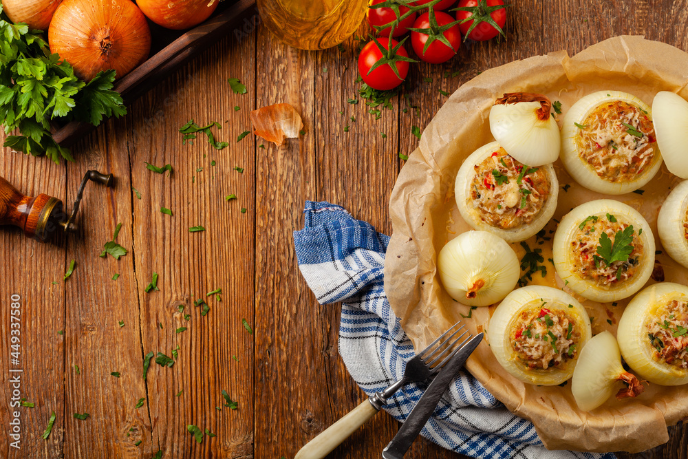 Onion baked with cheese stuffed with minced meat. Top view. Served in parchment. Onion baked with cheese stuffed with minced meat. Top view. Served in parchment.