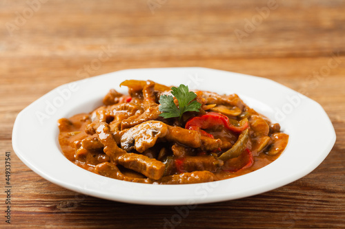 Boeuf, Stroganow, Strogonow. Classic, Russian beef stew. Served on a white plate. Front view. Natural background.