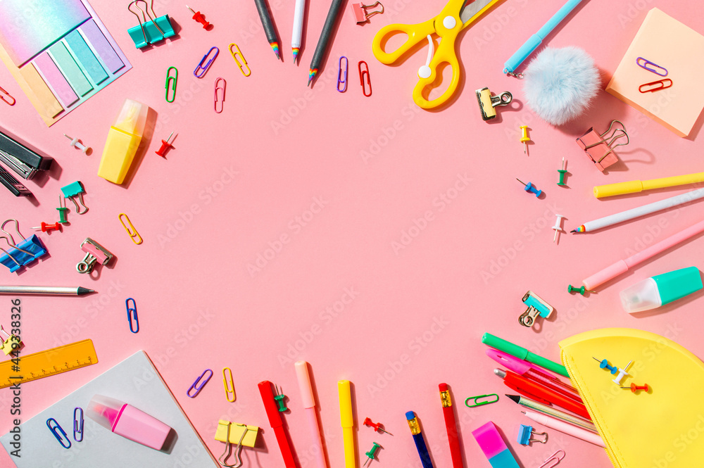 Creative student desk with school supplies and copy space in center. Top view or flat lay. Trendy back to school flat lay on pink background Creative student desk with school supplies and copy space in center. Top view or flat lay. Trendy back to school flat lay on pink background