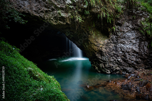 Natural Bridge with waterfall into cave photo