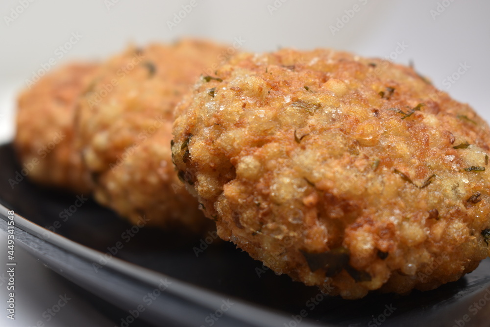 closeup shot of sabudana wada or shabudana vada resting on each other closeup shot of sabudana wada or shabudana vada resting on each other
