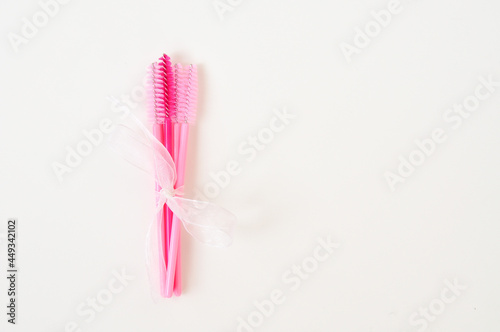 colored brushes for lash extensions in beauty salon materials for lashmaker on white background  copy space