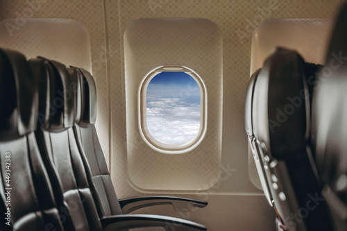 Airplane window in clear sunny weather. Interior of a passenger plane with an open window in flight