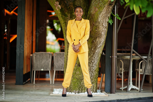 Portrait of nice-looking fashionable attractive lovely content cheerful cheery african american girl wear bright vivid shine vibrant yellow color jacket or costume.