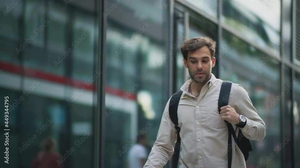 Young businessman walking down the street Young businessman walking down the street