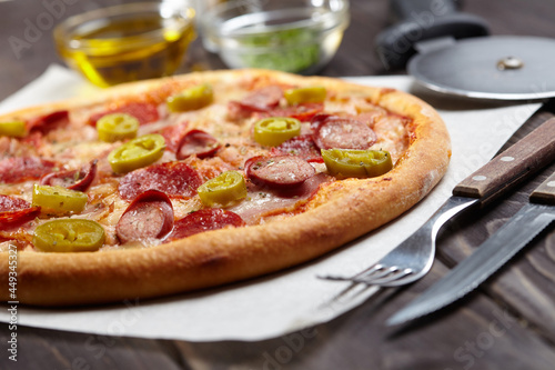 tasty pizza on the wooden background