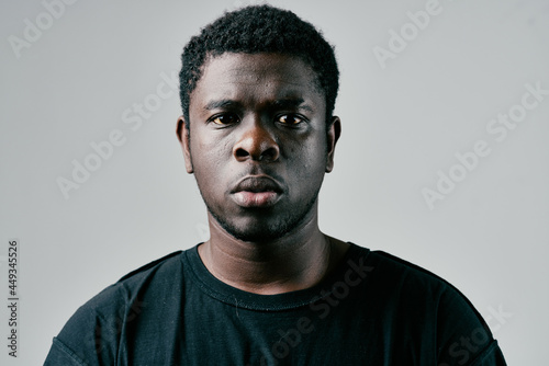 African man in black t-shirt fashion studio posing close-up