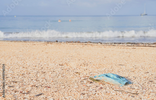 Wallpaper Mural Sanitary mask abandoned on the beach by tourists. Environmental pollution concept. Can Pastilla beach, Palma de Mallorca. Torontodigital.ca