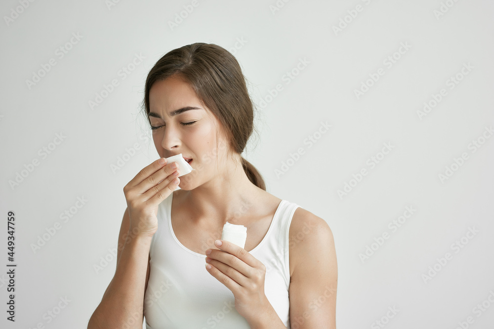 woman in white t-shirt blows her nose in a handkerchief depression infection woman in white t-shirt blows her nose in a handkerchief depression infection
