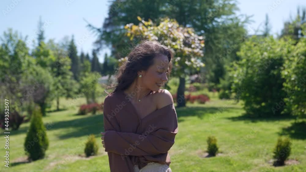 portrait of a happy carefree woman smiling on a walk in the park in the morning