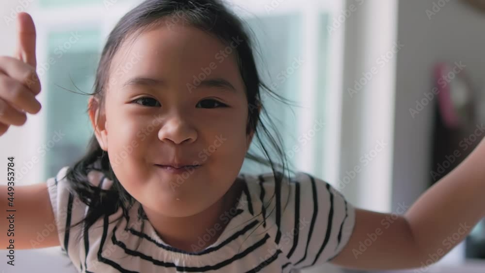 Asian girls are doing funny poses happily. Children are making funny faces. Hand-held 4k slow-motion footage Asian girls are doing funny poses happily. Children are making funny faces. Hand-held 4k slow-motion footage