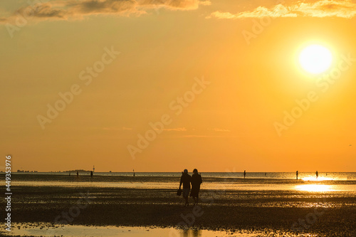 silhouette of a couple walking on the beach