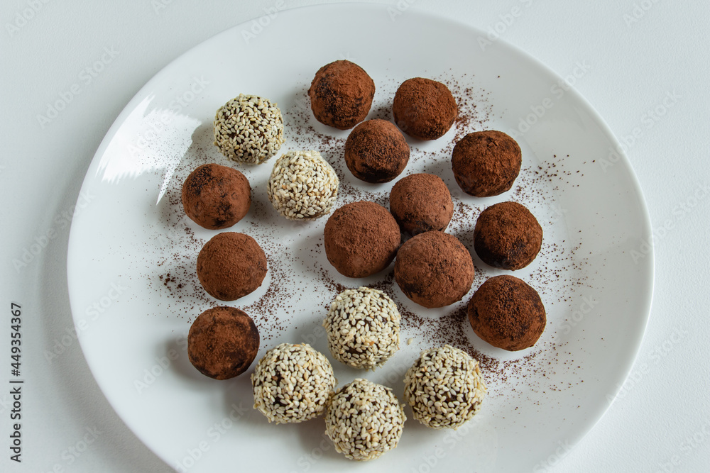 truffles with cocoa, coconut and sesame seeds with chocolate and marshmallows, delicious dessert on a white background truffles with cocoa, coconut and sesame seeds with chocolate and marshmallows, delicious dessert on a white background