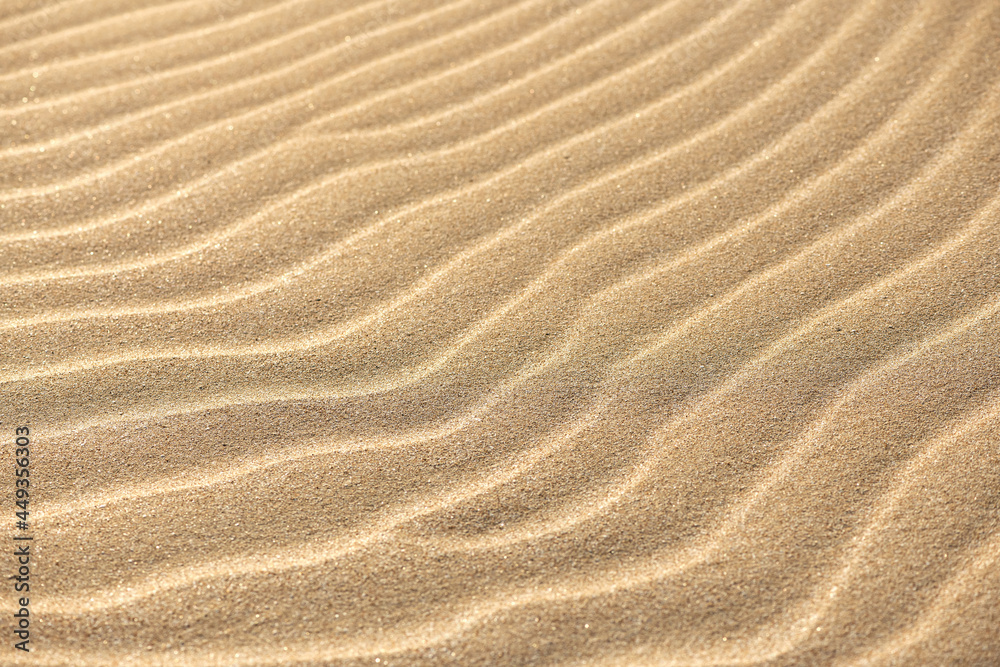 Wavy sand texture. Sand Dune. Desert in sunny day. Abstract golden background or wallpaper. Wavy sand texture. Sand Dune. Desert in sunny day. Abstract golden background or wallpaper.