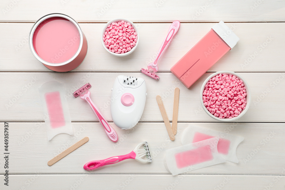 Set of epilation products on white wooden table, flat lay Set of epilation products on white wooden table, flat lay
