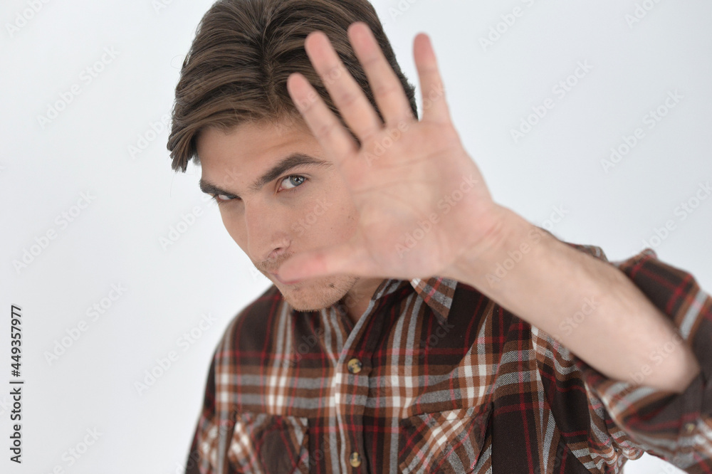 handsome young man gesturing stop in studio handsome young man gesturing stop in studio