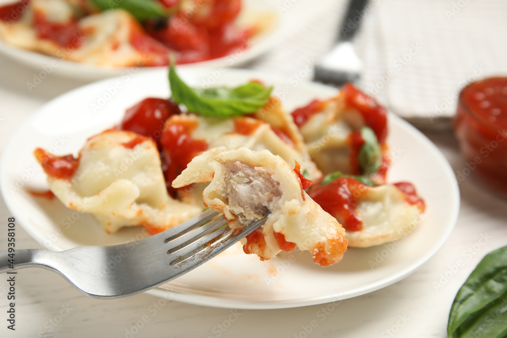 Eating traditional ravioli with tasty filling, closeup