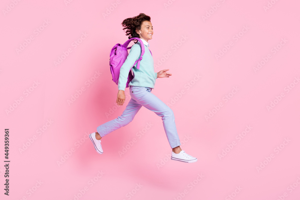 Profile photo of active sporty boy jump hurry knowledge day wear backpack teal shirt isolated pink color background