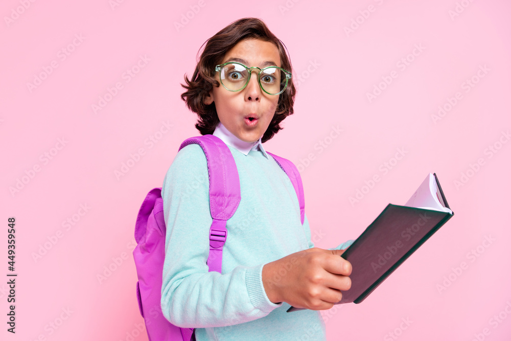 Photo of shocked surprised boy hold textbook open mouth wear eyewear bag teal shirt isolated pink color background