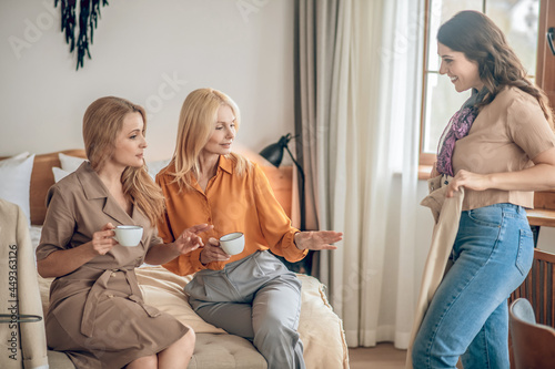 Group of women spending time together and discussing new fashionalbe clothes photo