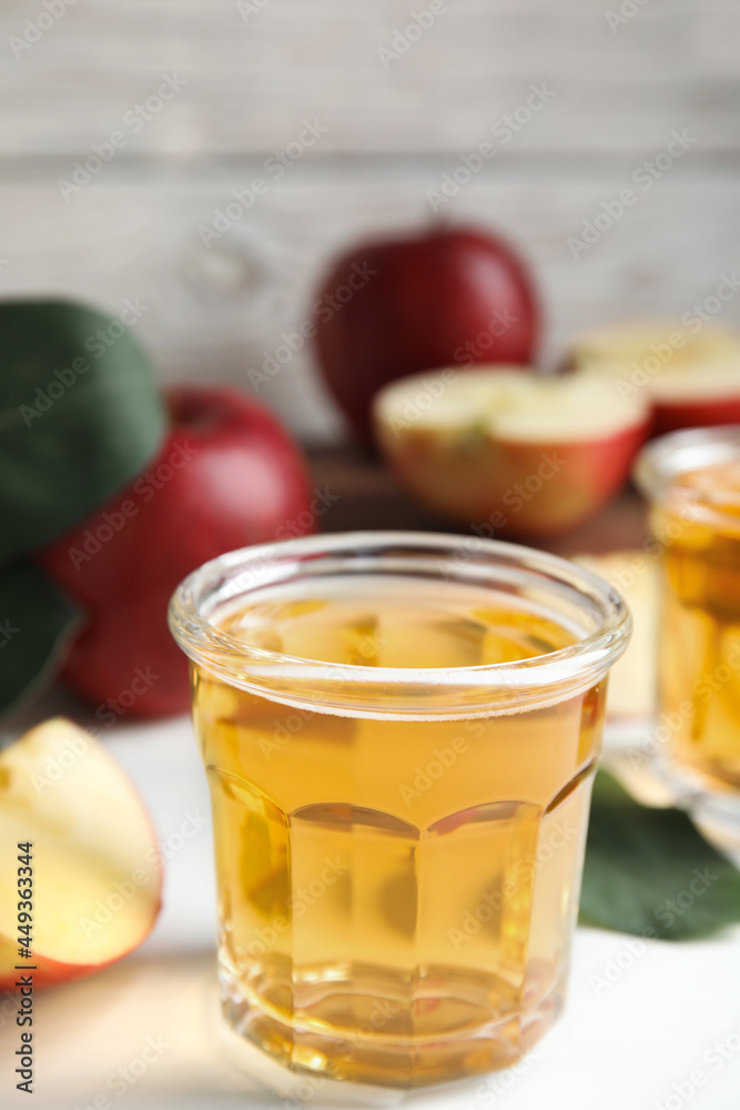 Glass of delicious apple cider on white table. Space for text Glass of delicious apple cider on white table. Space for text
