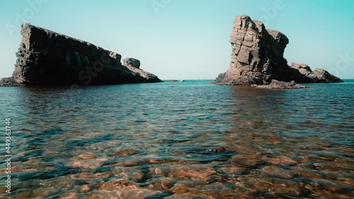 Low angle view of natural landmark The stone ships near Sinemorets, Bulgaria. Colorful landscape of rocks in calm blue sea water during a sunny day. Waves crashing on coast
