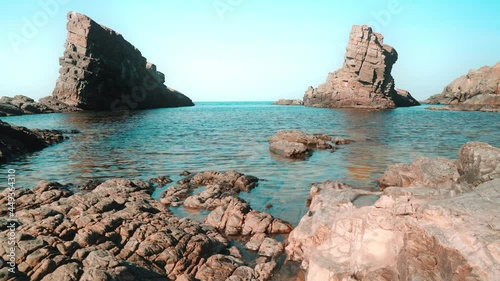 Low angle view of natural landmark The stone ships near Sinemorets, Bulgaria. Colorful landscape of rocks in calm blue sea water during a sunny day. Waves crashing on coast