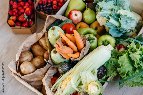 Closeup of box full of various organic vegetables  fruits and berries. Food delivery concept.