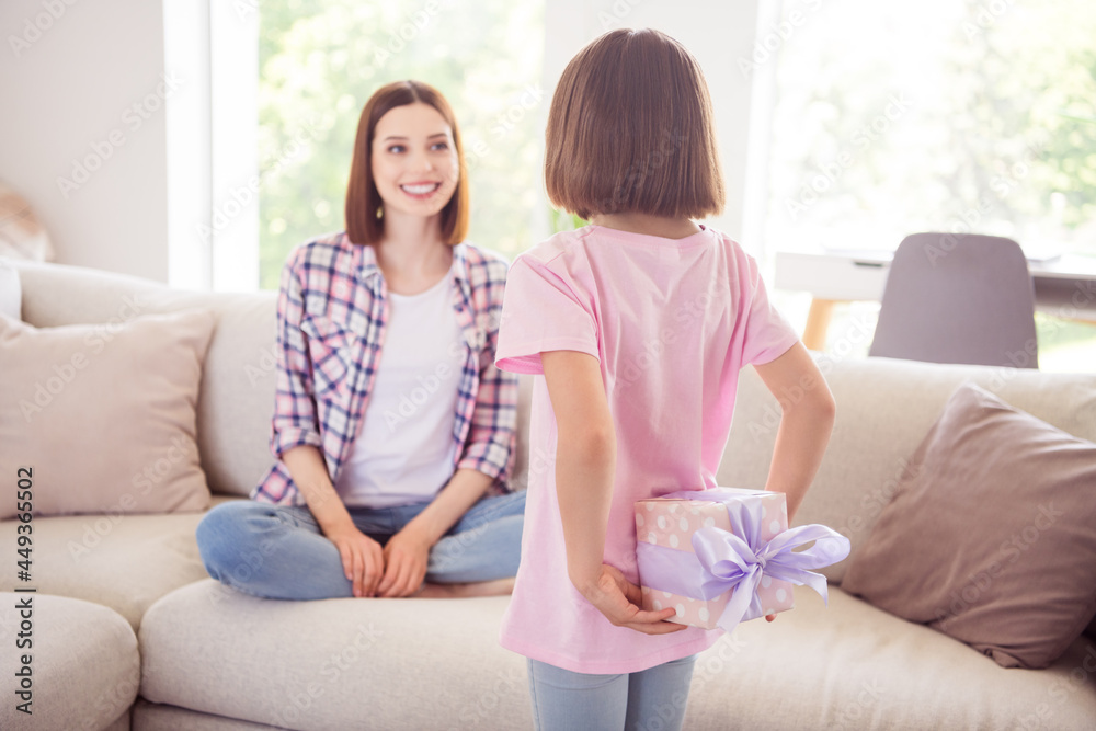 Photo of young happy woman younger sister hold hands gift present surprise birthday indoors inside house home Photo of young happy woman younger sister hold hands gift present surprise birthday indoors inside house home
