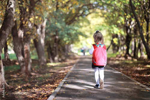 Children with briefcases for a walk in the park. School break. The beginning of the children's studies.