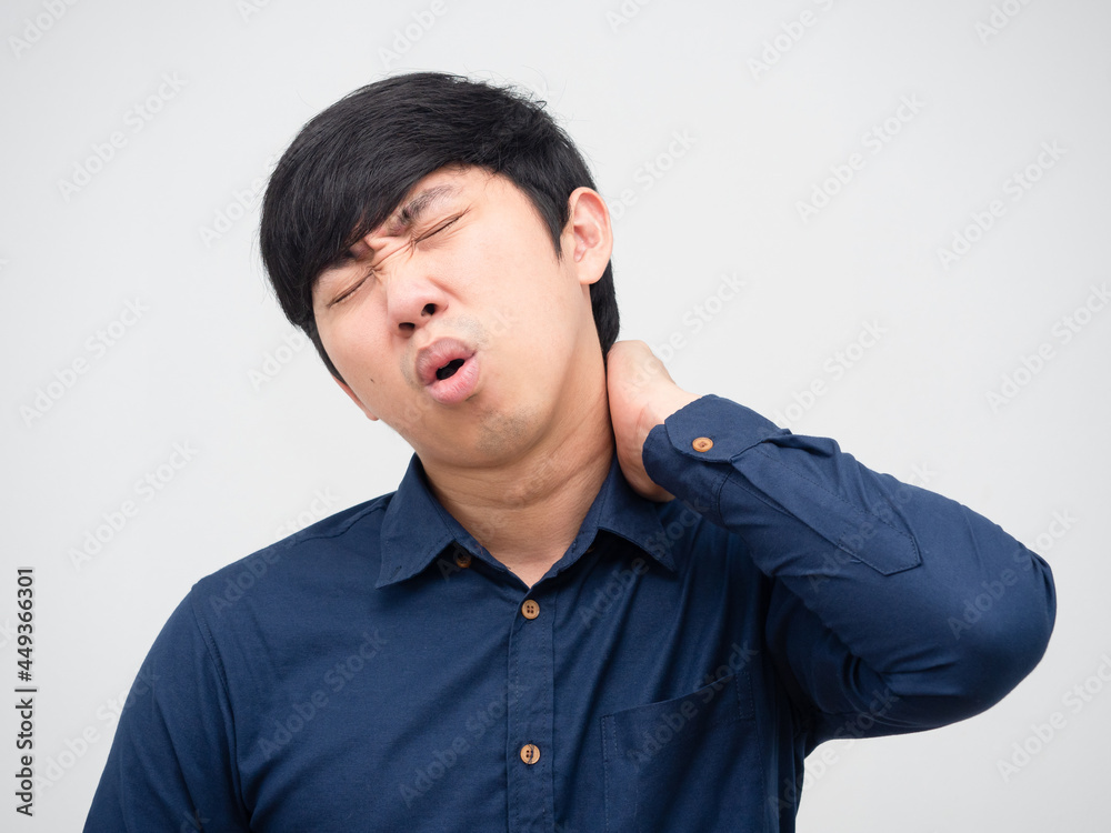 Man feeling pain his neck unhappy face portrait white background Man feeling pain his neck unhappy face portrait white background