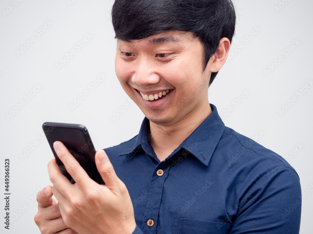 Cheerful asian man using mobile phone in hand happy face portrait Cheerful asian man using mobile phone in hand happy face portrait