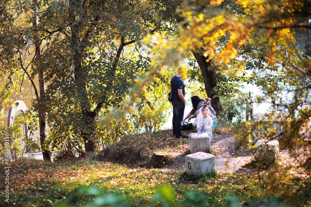 Leaf fall in the park. Children for a walk in the autumn park. Family. Fall. Happiness.