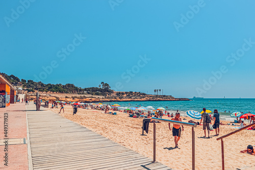 Tarragona Spain July 10, 2017 Sea landscape. Scenic old town with nice sand beach and clear blue water in bay.