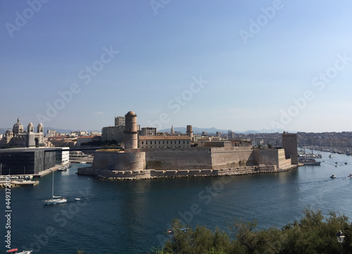 Panoramic view of Fort Saint-Jean with Marseille Cathedral and Mucem museum on the left and the entrance to the Old Port to the right, seen from the Pharo Palace in Marseille, France.