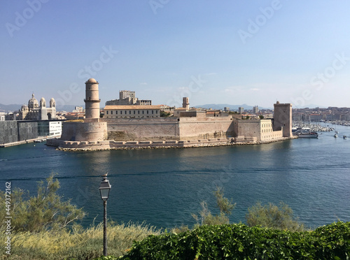 Panoramic view of Fort Saint-Jean with Marseille Cathedral and Mucem museum on the left and the entrance to the Old Port to the right, seen from the Pharo Palace in Marseille, France.