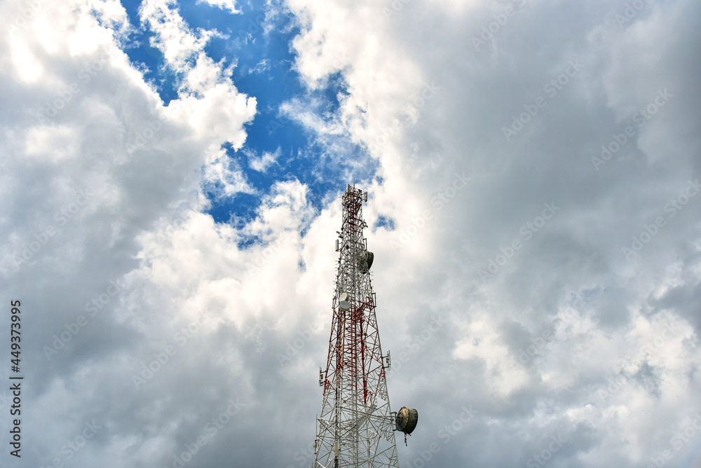 White clouds on blue sky with Telecommunication towers.