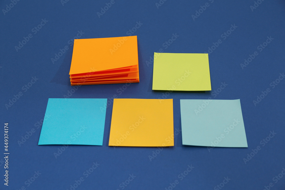 Different colorful sticky notes on blue background Different colorful sticky notes on blue background
